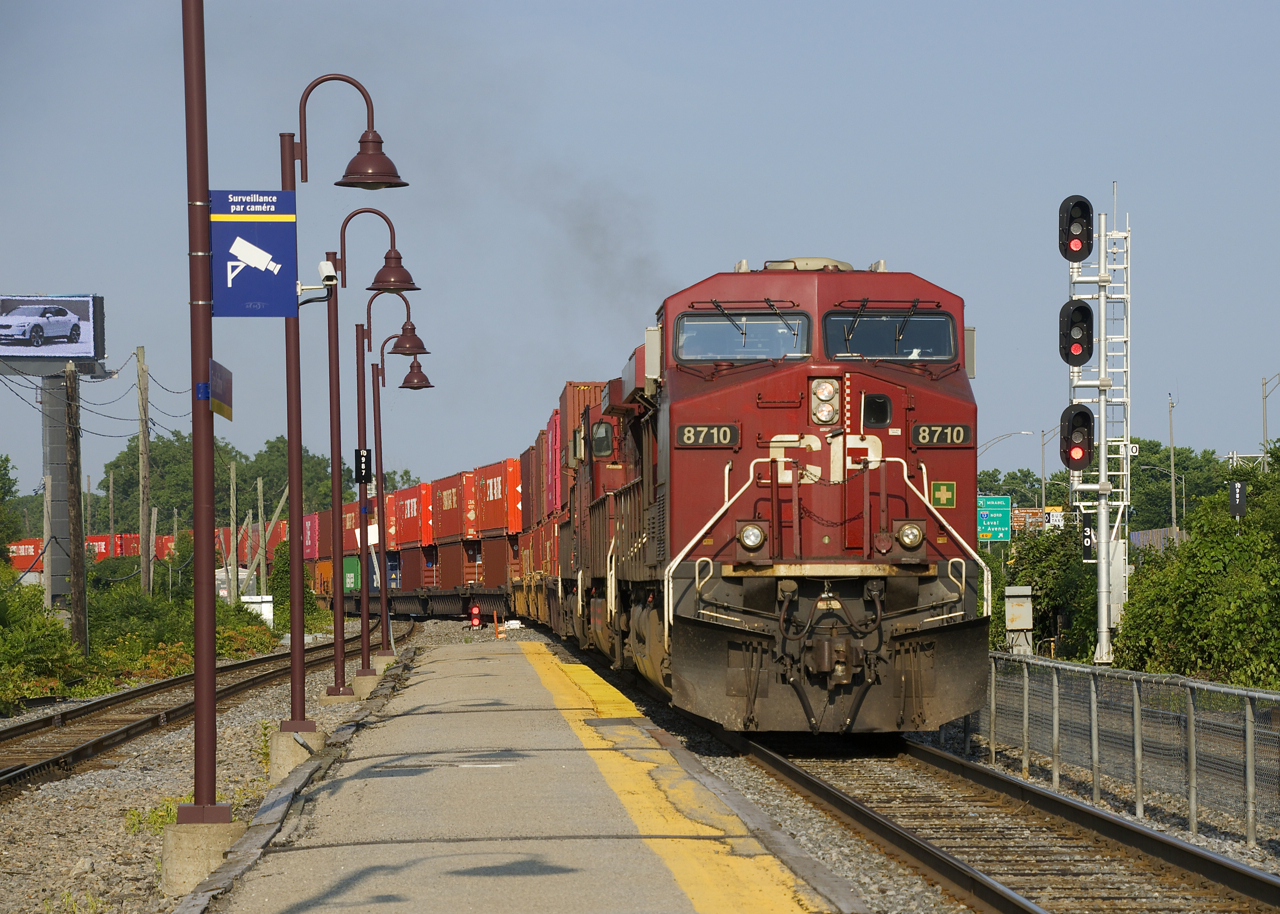 CP 119 is exiting Lachine IMS Yard with a long string of intermodal cars before backing up to the rest of its train.