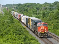CN 2884 leads CN 322 eastwards through Beaconsfield, with CN 377 lined on the north track in the distance.