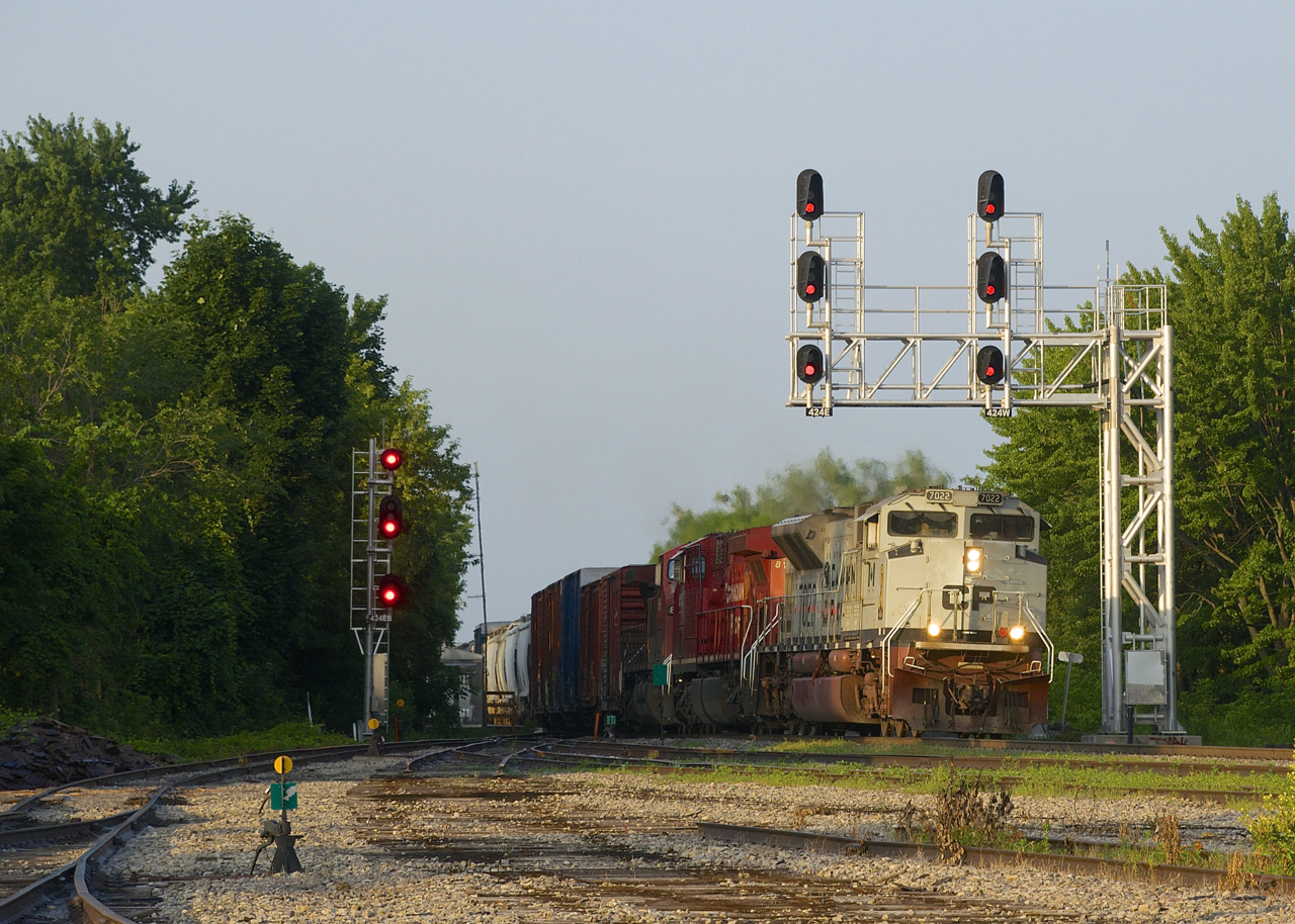 It's quite early in the morning as CP 253 is approaching Lasalle Yard with Navy unit CP 7022 leading CP 8155 & CP 8566. A late edition of counterpart CP 252 had just left here five minutes earlier after holding for a boat going through the St. Lawrence Seaway.