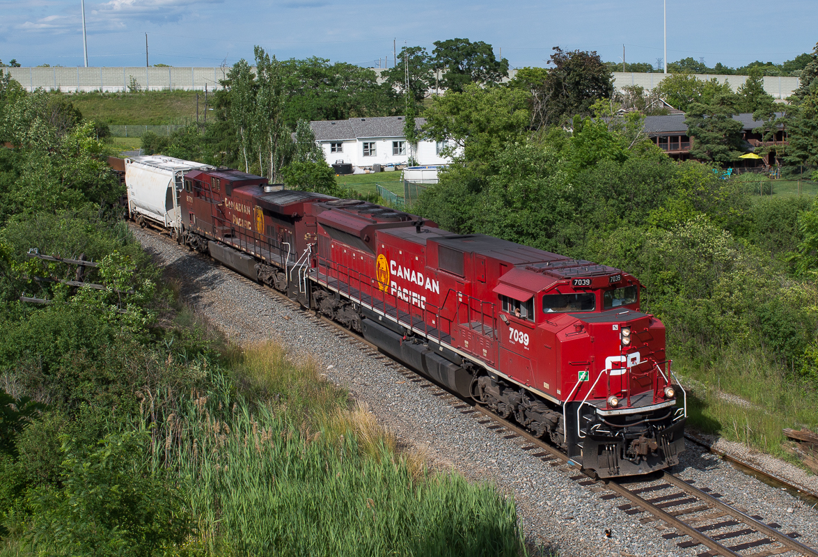 CP 254 slowly rolls by Newman Road as they approach Hamilton and their stop at Kinnear.  Leading todays train was ACU 7039 which was a nice change of pace from the usual GE leaders of late.