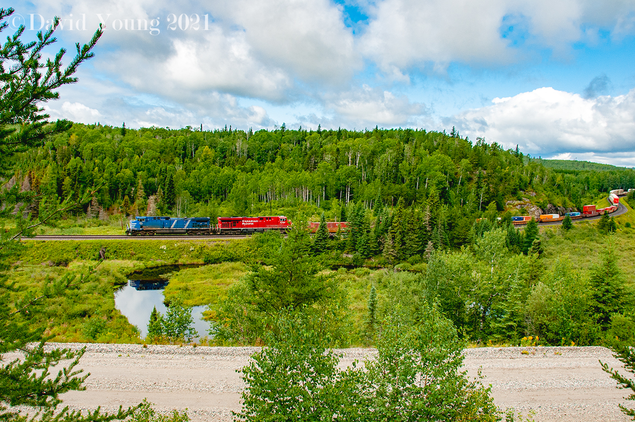 CEFX 1035 and a fresh CP 8784 lead South Edmonton to Vaughn train 104-15, beginning their descent into the Lakehead, cresting the short, steep grade a mile or so earlier- a precursor to the heavy grades which await ahead. Not that they will be an issue for this eastbound hotshot.