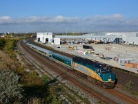 <br>
<br>
   Construction of the GO East Rail Maintenance Facility progresses, with the west side railbeds partially installed,
 <br>
<br>
   as VIA #6401 leads the mid morning J train,  #62  to Montreal and  #52 to Ottawa (with 6434 ) ,  slowing for the Oshawa station stop,
<br>
<br>
   and in the background the tail end of an auto parts / auto racks westbound exits the south service track  powered by a CN  8889 / 2191 / 5442   combo:  SD70M-2 /  Dash 8-40 CW  / SD60; 
<br>
<br>
   Image from the since removed Hopkins St overpass, Whitby, October 12, 2016 digital by S.Danko
<br>
<br>
   Noteworthy: 
<br>
<br>
The GM Oshawa plant ceased production December 2019. There will be a return of  auto parts/ racks action  (whether CP may be involved n/k ) at the renewed GM facility: pickup production is targeted to begin in January 2022 with the next-generation Chevrolet Silverado and GMC Sierra, including their heavy-duty variants. 
<br>
<br>
