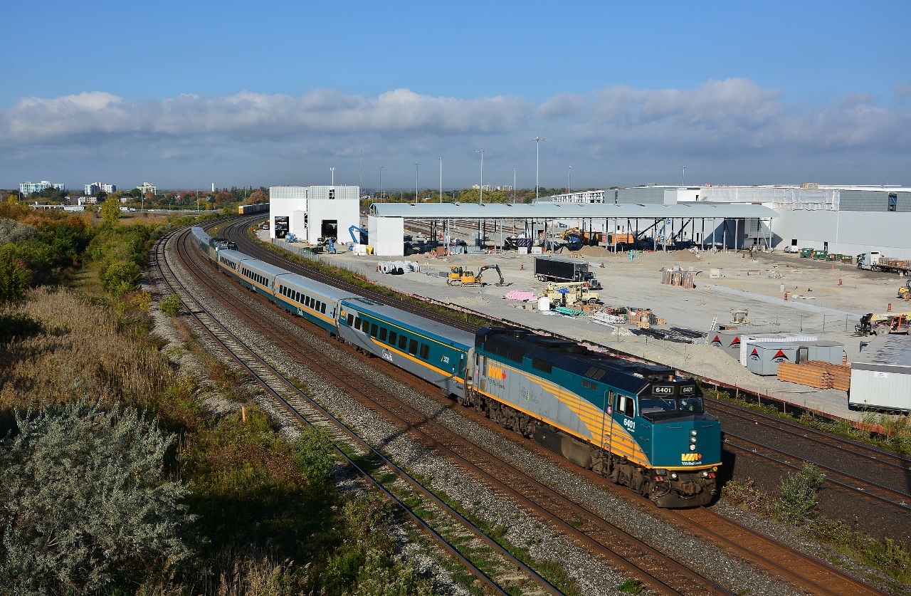 Construction of the GO East Rail Maintenance Facility progresses, with the west side railbeds partially installed,
 

   as VIA #6401 leads the mid morning J train,  #62  to Montreal and  #52 to Ottawa (with 6434 ) ,  slowing for the Oshawa station stop,


   and in the background the tail end of an auto parts / auto racks westbound exits the south service track  powered by a CN  8889 / 2191 / 5442   combo:  SD70M-2 /  Dash 8-40 CW  / SD60; 


   Image from the since removed Hopkins St overpass, Whitby, October 12, 2016 digital by S.Danko


   Noteworthy: 


The GM Oshawa plant ceased production December 2019. There will be a return of  auto parts/ racks action  (whether CP may be involved n/k ) at the renewed GM facility: pickup production is targeted to begin in January 2022 with the next-generation Chevrolet Silverado and GMC Sierra, including their heavy-duty variants.