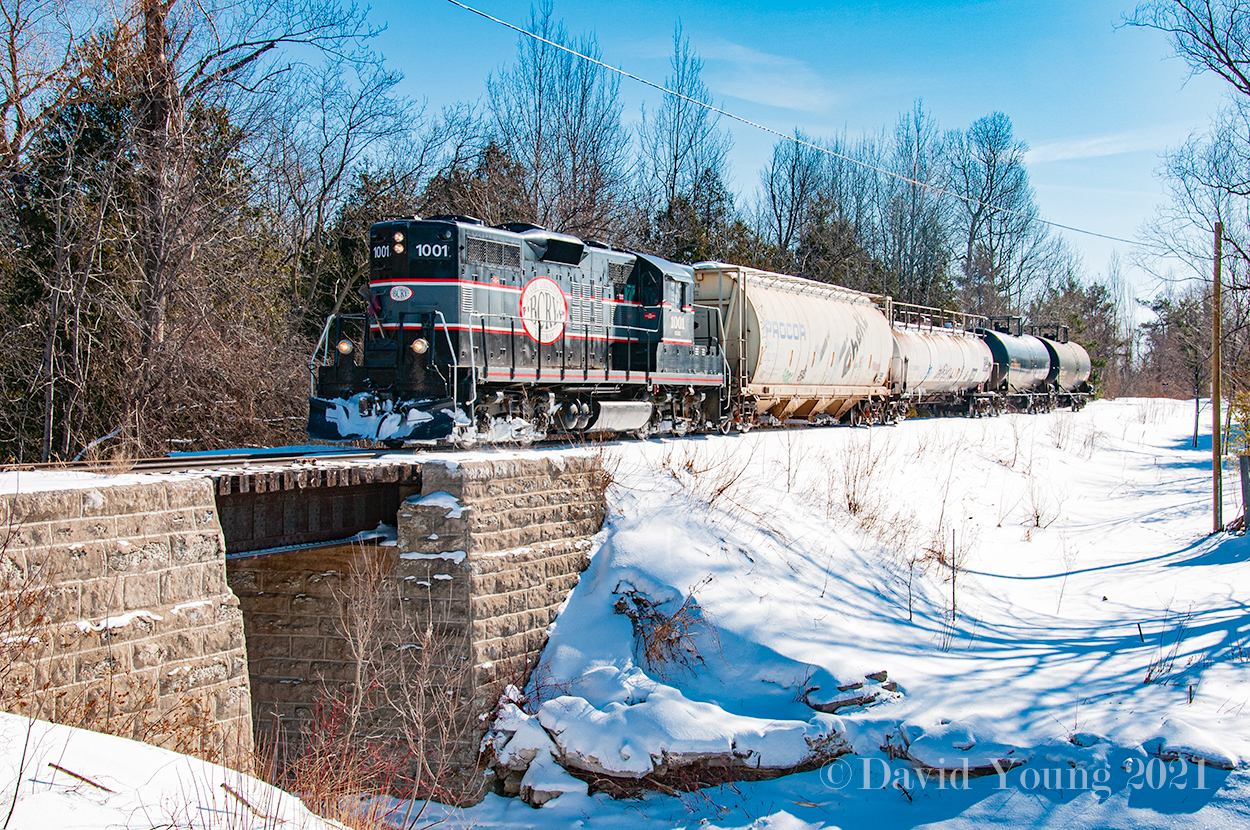 The only time to date I've capture the Barrie-Collingwood Railway running was back in February 2009 as they headed north to Collingwood to service Canadian Mist Distillers. On this bitter February day, The Spirit of Collingwood with a hopper for FS Partners in Stayner and three tanks for Canadian Mist in tow pictured here northbound passing over the quaint and attractive bridge over the Batteaux Creek.