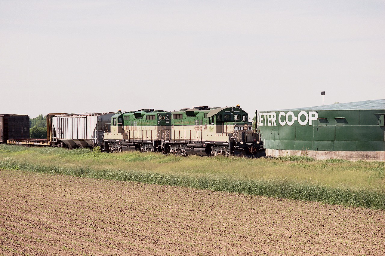The fledgling GEXR was barely 3 months old when this image was taken.  Northward GEXR 179 and 180 with a small train pass the Hensall-Exeter Co-op on the way back to Goderich on a quiet weekday afternoon. Slow track speeds made this a leisurely "chase".