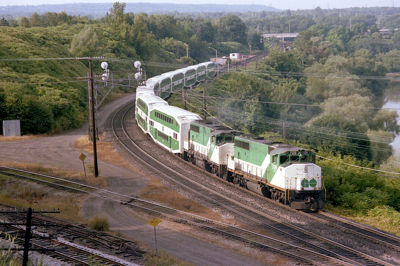 While looking over this photo, I found it so hard to believe that these two GO locomotives, 709 and 702; became part of the CN fleet 30 years ago already, (CN 9676 and 9671) Trailing is APCU 903, formerly ONR's FP7A 1512. I liked the angle here but often chose a different location due to all those wires cluttering up the scene.
In the background in this photo I see a few of the lads hanging out at Bayview Jct. As usual.