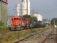 Taken from the Depew St. grade crossing in Hamilton's industrial north end, the CN 0700 job heads east to Parkdale Warehousing while one of the CP yard jobs traverses the Belt Line in the background. Power was GT(CN) 6420-CN 7083-CN 1412. 