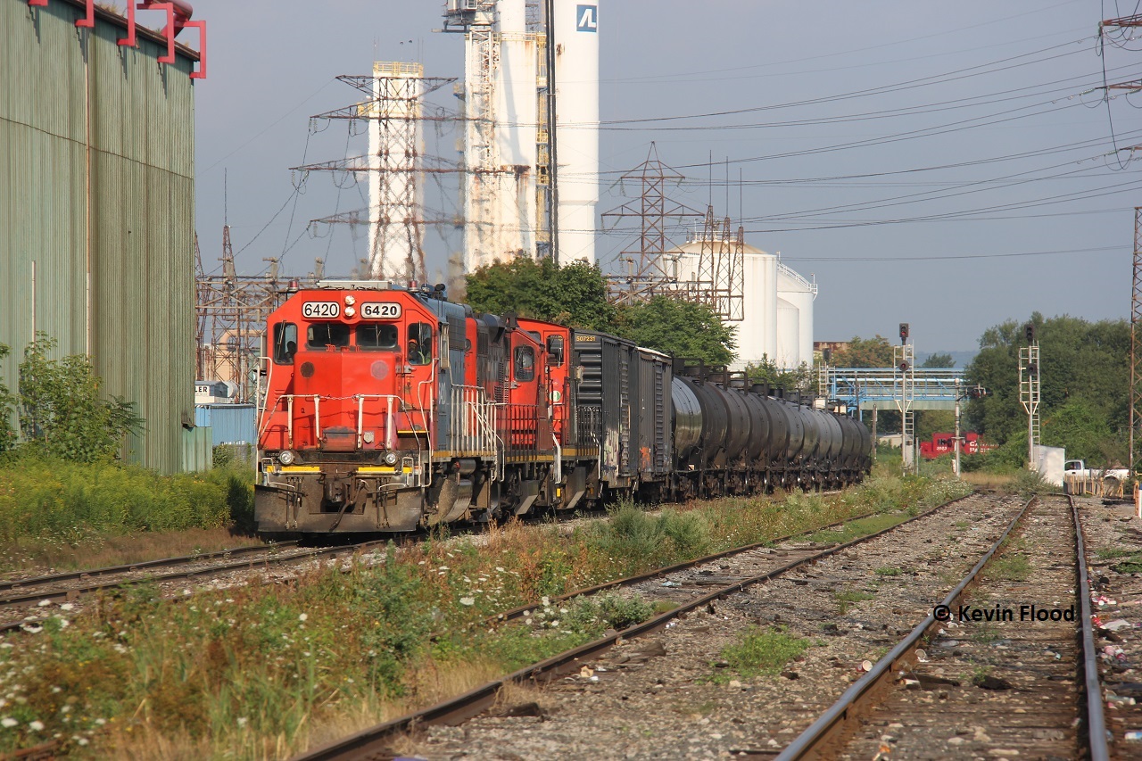 Taken from the Depew St. grade crossing in Hamilton's industrial north end, the CN 0700 job heads east to Parkdale Warehousing while one of the CP yard jobs traverses the Belt Line in the background. Power was GT(CN) 6420-CN 7083-CN 1412.