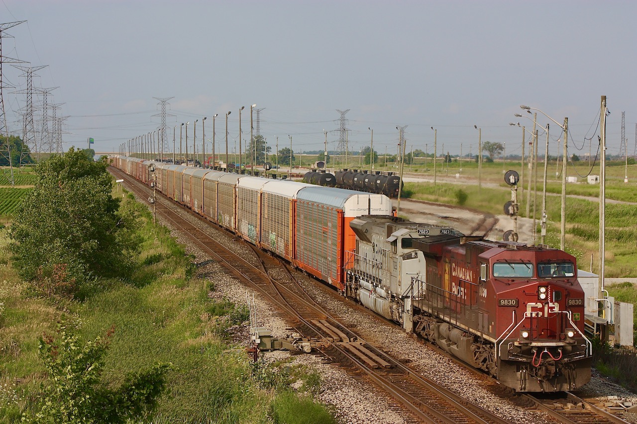 CP train 147 storms past Hornby East with military tribute SD70 7023 trailing. The former Expressway yard can be seen in the background, and is now a transloading facility operated by Cando contracting.