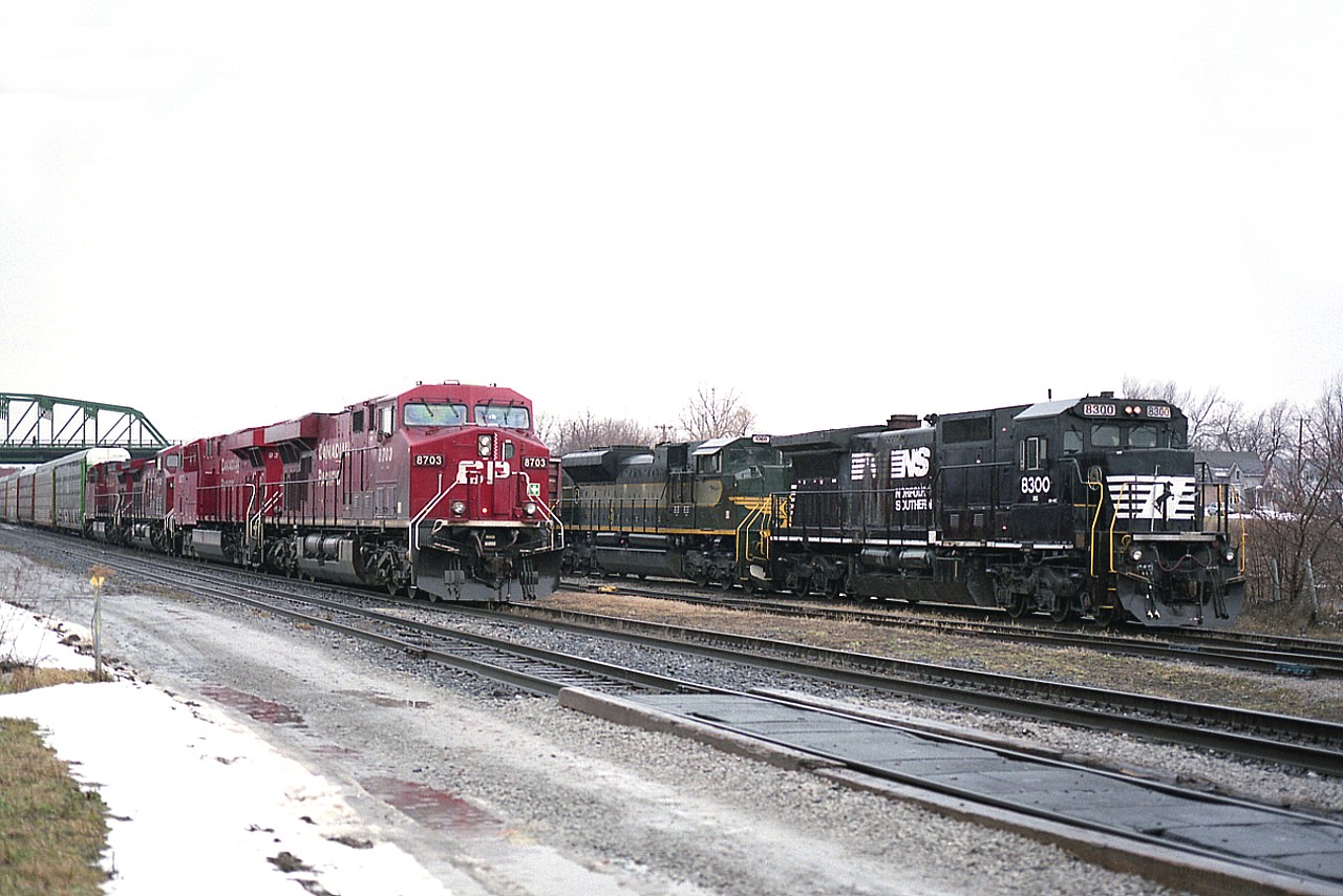 Until the recent 'special paints' at Fort Erie, I found it had been awhile since I had seen anything "Heritage" come across on the transfer train.  This shot is already 8 years ago; NS 8300 with 1068 in 'Erie' heritage paint wait in the rain for a 4 unit CP #246 led by CP 8703 to cross ahead of it.
Actually the rain sort of suits photos down in this area, as the image appears almost as depressing as this area itself has become.  A real shame.