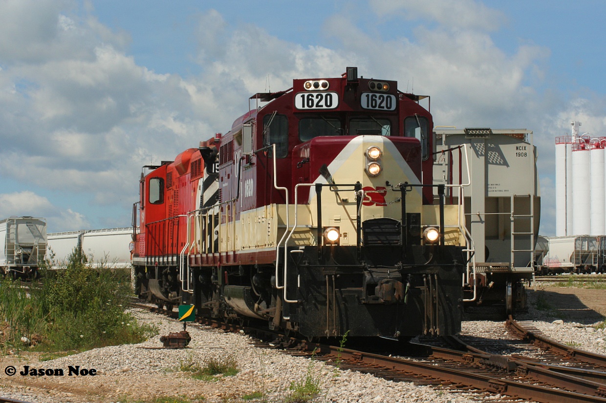 Ontario Southland Railway (OSR) Job #1 with GP9u's 1620 and 1591 work the large Polymer Distribution Inc. (PDI) facility at Massey Road on the Guelph Junction Railway (GJR) South Industrial Spur in Guelph, Ontario.