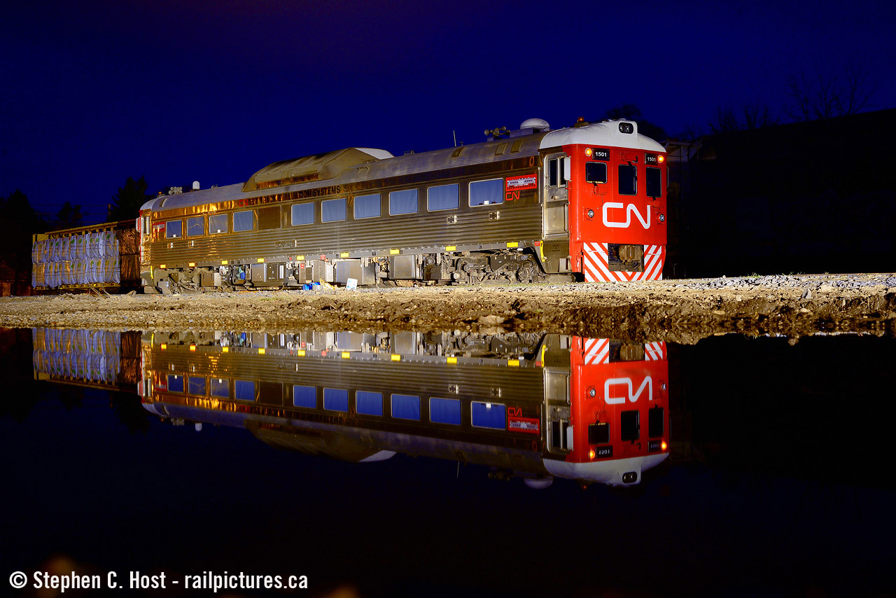 With 1501 parked in Guelph, I took the opportunity to shoot it and found a nice puddle to reflect it in. I did a shot of it in daylight and decided to go back at night and give it another try.
I also shot this thing being sent to CN (as 15016) for rebuild. Built in 1958 as CN D-108, it's been neat to see this thing return to CN and basically travel coast to coast to coast every year and thensome.