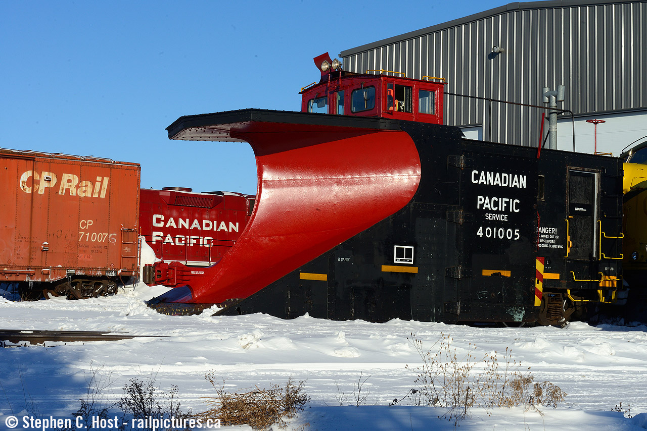 Winter 2014 was a doozey, and 2015 proved to be almost as good, with plow trains running a couple times a month by both OSR and GEXR, you'd just read the weather, head to salford, and the always inviting Ontario Southland folks were more than OK with a few cameras around - and there were always a few cameras around. While waiting for the plow to be ready to depart,I was wandering the grounds where I found this scene showing three generations of CPR logos in a single photo: 1920's, 1970's, and 2000's. The GP38 was in for work as ZTR was leasing space in the Salford shop to work on some CP units and a couple dozen made the rounds over the years.

Here's the action shot taken 40 minutes later at around 10 AM. The wait was not long and the snow was fluffy, light, and beautiful. One of the best days for a plow I've ever shot.