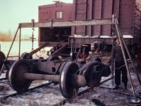 A photo taken by my Dad while working on a box car that was left BO'd in a siding somewhere in the Edmonton area. Now that the wheel has been rolled down the ramp onto the track, how did they get it over to the track with the truck? :-)
