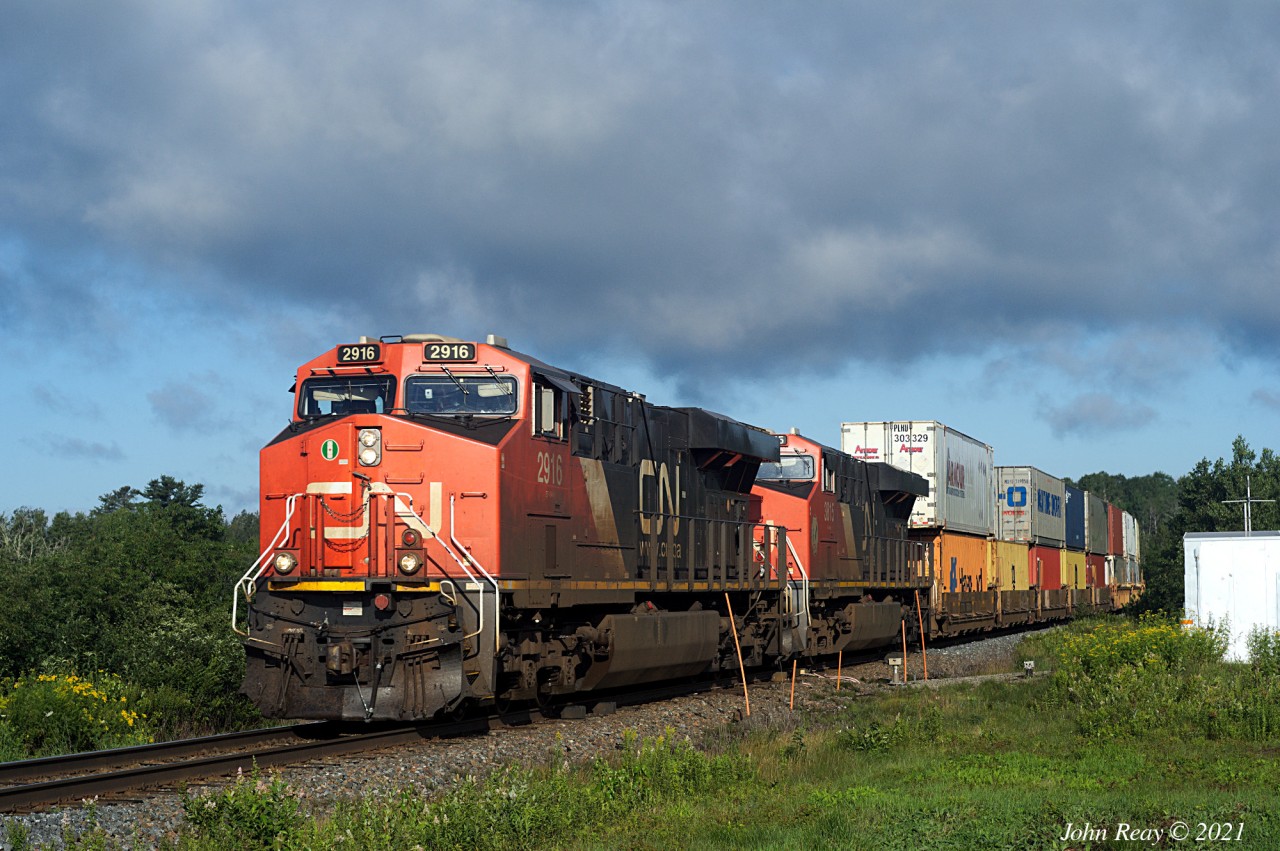 July 31st, 2021 @ 08:14, CN train Z120 passing over the defect detector at MP 42.5, CN Springhill sub (Thomson Stn.) With CN 2916, CN 3815 trailing 446 axles at a reported 57 mph. DPU CN 2901 is mid-train. Dramatic morning sky.