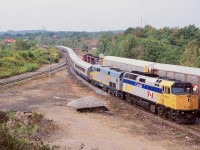 Fond memories of busier times, I think this was the only time I ever caught 3 trains in a frame here. The morning hours were often quite busy up on the berm at Hamilton West, and typically VIA train 70 was one of the best VIA trains to catch. It often deadheaded extra train sets out of Windsor and this day was no different. Here VIA train 70 passes CN 391's head end, while the CP local with a GP9U and two SW1200 "pups" have a lone car in tow for a customer in Watertown. 