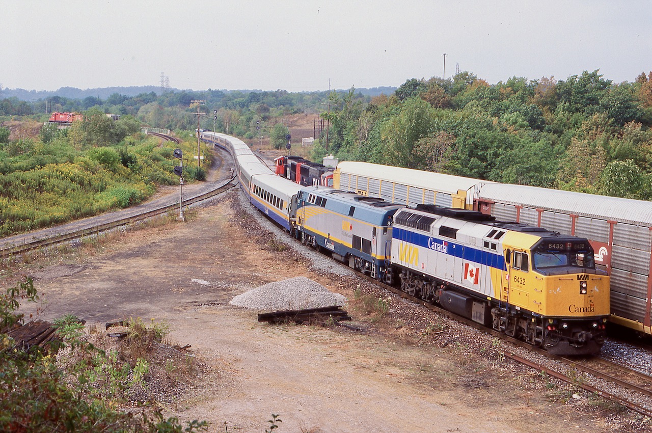 Fond memories of busier times, I think this was the only time I ever caught 3 trains in a frame here. The morning hours were often quite busy up on the berm at Hamilton West, and typically VIA train 70 was one of the best VIA trains to catch. It often deadheaded extra train sets out of Windsor and this day was no different. Here VIA train 70 passes CN 391's head end, while the CP local with a GP9U and two SW1200 "pups" have a lone car in tow for a customer in Watertown.