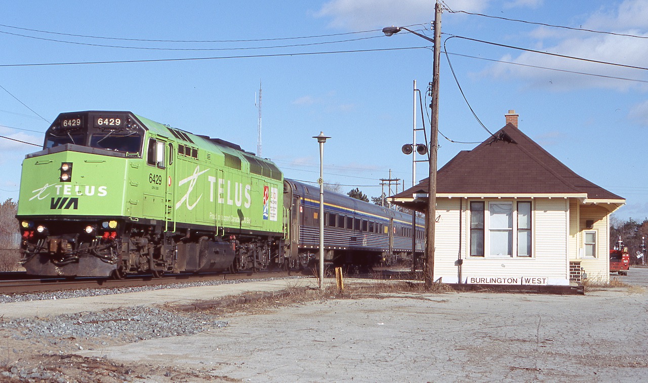 A follow up photo to my previous one taken a few years earlier at the same location, this one shows VIA 6429 after it shed its Home Hardware paint for a coat of Telus green. The old station here has been refurbished but in a few years it will sit neglected again, sadly outliving its use as an actual station once the new GO station was built to the east of here and GO/Via station built at Aldershot. Thankfully the station survives today a few blocks away, restored as a museum.