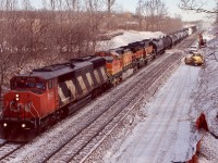 The rebuilding of the new plant at Snake was well under way as CN train 399 cautiously rolled by. The SD50's were nearing retirement by this time and BNSF power on this train was almost the norm, although the GP60"B"s were somewhat rare. New track sections can be seen off to the left up on the hill.