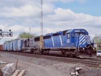 Aldershot East was I nice go to location if one missed a train working the yard, even if not all that scenic. unfortunately when the subdivision was rebuilt, the crossing at King Road was turned into a bridge. Back in 2006 it was still a level crossing and came in handy after catching CN 390 with a power set off CSX consisting of a former SP SD45 rebuilt into a SD40 for CEFX, trailing it was a CSX SD50. The power has just finished making a lift at Aldershot yard and now has a nice cut of rebuilt GT boxcars up front. The train is passing the soon to be removed signal bridge as a third main track will soon be installed in its place.