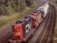 This was one of those rare lucky trips back from Toronto that actually graced me with a freight train. By this date freight activity through downtown Toronto was rare to come by, although much worse these days. Sadly almost all rail served industries near Toronto's downtown core have vanished in recent decades, with most factories either demolished or repurposed. This also led to the demise of CN Don yard on the Eastside of downtown, today it is a GO/Metrolinx storage yard, and it appears that the Portlands no longer has rail service either. Back in 2007 CN still ran at least one local between Mimico and Don yard along with through trains 434/435. This day long hood forward GP9RM 7038, and 4107 (with spark arrestors still intact) have a very short train in tow as they roll along the Gardiner Expressway and past the Exhibition's Dufferin Street gate with its arch in the distance. The train will soon arrive back at Mimico yard. Today with the Oakville subdivision east of Burlington West under Metrolinx ownership, freight traffic during the day is scarce. There is only one local job currently that works east of Clarkson, and sadly this only happens under the cover of darkness, and typically only travels as far east as Mimico. 