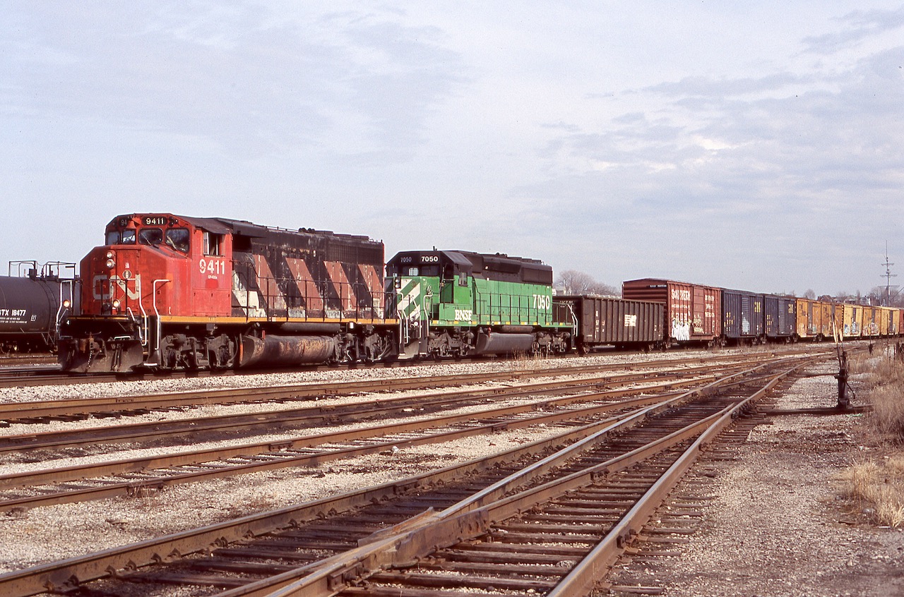It seemed back in the mid 2000's if you heard a train with a CN GP40 in the lead there was a pretty good chance something decent was trailing it. Back around that time former BN SD40's were common just about anywhere, either sub lettered for BNSF or for numerous leasing companies. No surprise considering Burlington Northern had the largest fleet of SD40's out of all the Class 1's. Here CN train 422 is seen rolling through Hamilton yard with CN 9411 and BNSF 7050.