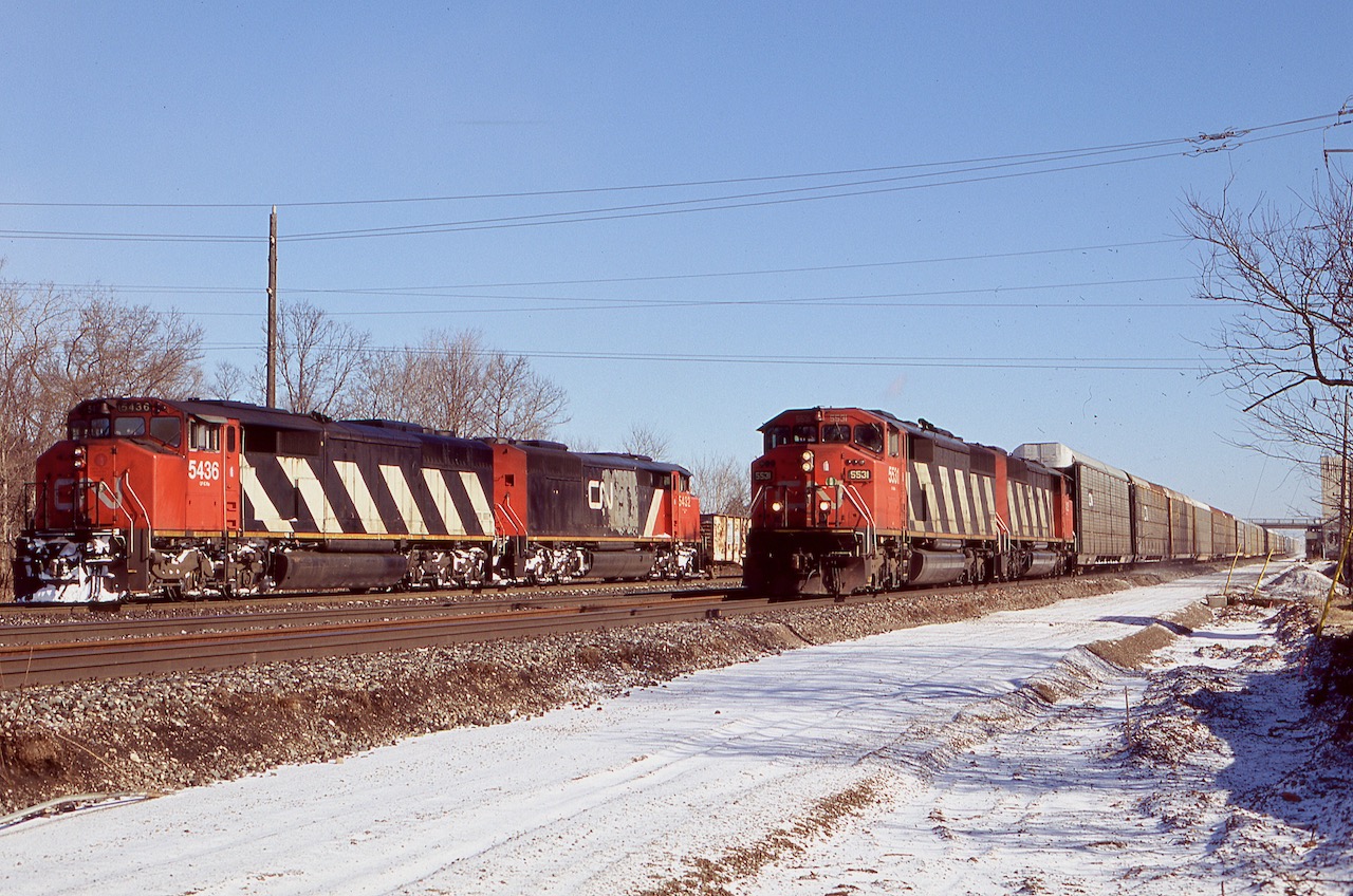 I think this is the only time I managed to catch two pairs of SD60 / SD50 cowls in one frame. As for the SD50's their days were definitely numbered and within a few years they were off the roster, as for the SD60's they lasted until a few years ago. Trailing 5432 I believe was the only SD50 to wear CNNA paint although the map by this date was in terrible shape. The new third track roadbed was levelled by this date and can be seen in the foreground, and the old Aldershot cold storage building was still standing.