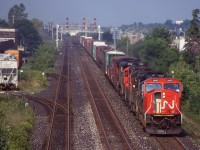 The Oakville sub. east of Burlington east hasn't been heavy with through freights in years but at least years ago it had a few trains polishing the rails. Aldershot yard must have been busy this day as CN 435 left its train east of Burlington West, taking only the cars to be dropped with it then returning as light power. Back then motive power was a decent mix with EMD/GE MLW and BBD power. In the consist this day was a borrowed NS C30-7 and a soon to be retired HR616 along with a few other not as interesting units. Unfortunately the rail served customers to the left are no longer there today and freight wise the Oakville subdivision here is much quieter under Metrolinx ownership today.