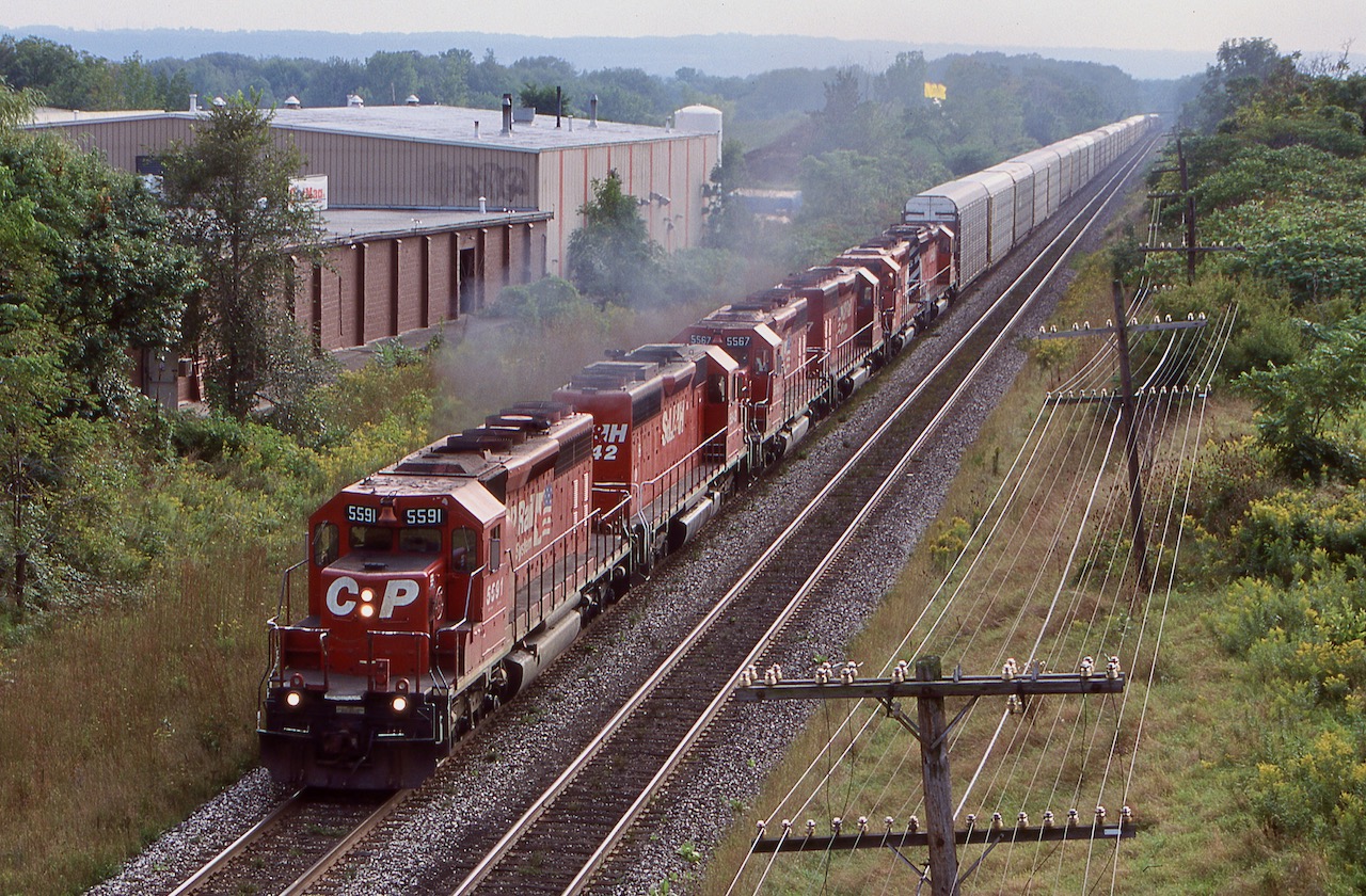 In my notes I have this train written as 525, hope that makes sense as in later years I never came across that number again. This day I was surprised with this much power the train was running over the Oakville sub. and not up the Hamilton sub. to Guelph junction, unless some of these racks were for the Ford plant in Oakville. By this date the old brick works in the background was history and the land was slowly being redeveloped into a residential community. That was not the only change coming to the area, but it would be several years before the Oakville sub. got a full upgrade and the last CP trains ran over the line.