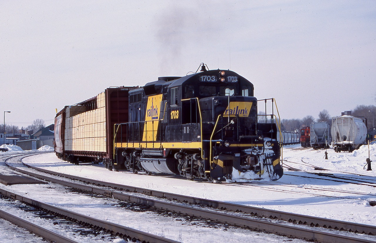 I always liked the former SP GP9 rebuilds that Railink picked up. This was a late production GP9 as it had the side mounted air tanks rather then the ones placed behind the fuel tank. I'm not totally sure of its previous road number but it should have been a 4200 before being renumbered into 1703. One of Railink's SW1200's can be seen in the yard behind, as 1703 is seen switching out Brantford yard on a cold February day.