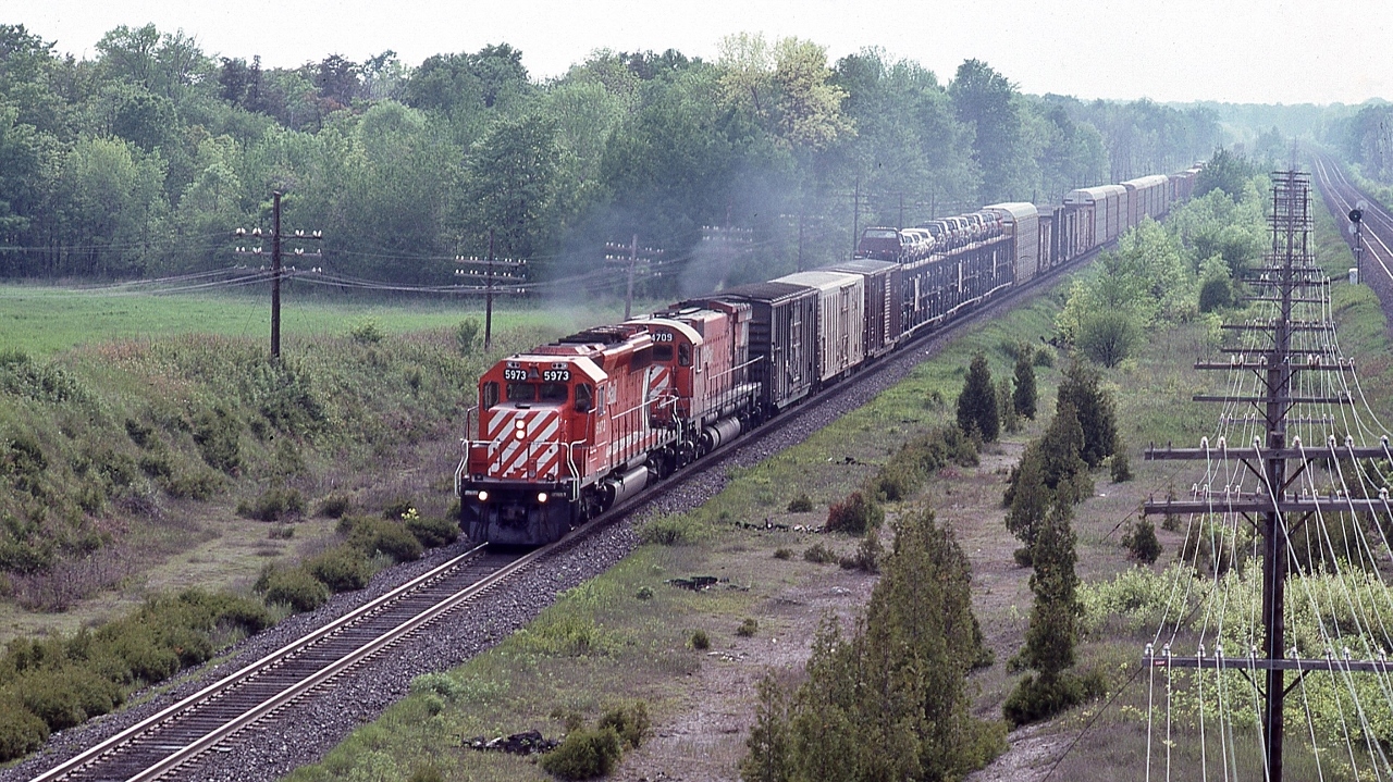 On a steamy June afternoon, CP Rail #916, powered by SD40-2 #5973 and M636 #4709,  head end is clear of Spicer 


   At mile 131 Belleville Subdivision, June 11, 1983 Kodachrome by S.Danko


   other end: 


       end – of – train device