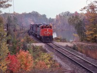 <br>
<br>
   A favourite time of year.... a favourite location....
<br>
<br>
   A mixed freight with mixed power...   
<br>
<br> 
 CN Extra 9576 North with two geeps (  GP40-2L(W)  )   and a C-424,
<br>
<br>
   GMD 1975 built # 9576  ( on roster as of 2017 )  /    MLW 1966 built # 3212  (ret by 1989)  /  95xx , 
<br>
<br>
   At mile 88.2 Bala Subdivision, September 29. 1979 Kodachrome by S.Danko
<br>
<br>
   Noteworthy: sans 'ditch lights'
<br>
<br>
   interesting: six of the final seven in the series # 9671-73; 75-77 were ex GO # 704-06;708-10)  
<br>
<br>