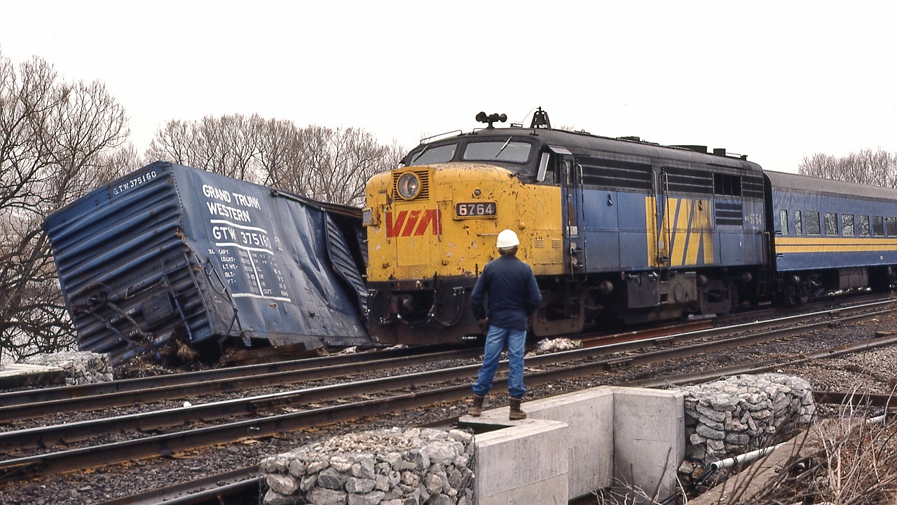 Foreman to Engineman #6764 East:  ' ... oh, just push it out of the way … those FPA-4's are tough ...'


   ... so it appears....


   At CN Beachville, February 18, 1984 Kodachrome by S.Danko


   Noteworthy: 


February 14, 1984: A 25 car CN train derailed four miles west of Woodstock ( Beachville) causing $1 million damage. Half mile track torn up, propane tankers included in consist. Heavy rains blamed for weakening the track bed. Reportedly every spring new remnants of the derailment can be seen along the Beachville Thames River Trail – pushed up by the winter frost.