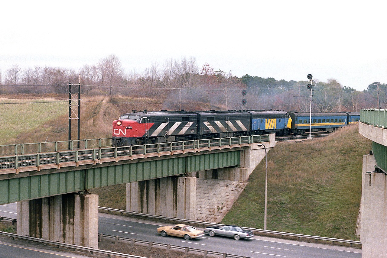 I guess this is actually Dundas. City boundaries confuse me around there.  Anyway, I loved the period of transition on the newly formed VIA Rail Corporation, especially for images like this.  The old CN and the new VIA. Quite the contrast.  I am on the north side of the Hwy 403 catching the westbound passenger; and on the extreme right is the CP bridge. Off limits these days, but a nice place to shoot way back when.
Power is CN 6789, 6660 and VIA 6537. Because this image was shot on a Sunday, I am wondering if this is train 71. It isn't #75 because it would be getting too dark already in November.