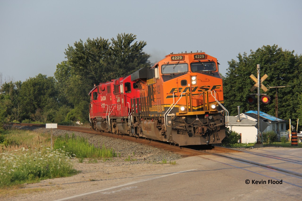 CP T69 is westbound at Drumbo just before 19:00 on a pleasant summer evening. The BNSF tagged along on the eastbound run to Guelph Jct. earlier and stayed on westbound to London. This light power move included BNSF 4229-CP 2269-CP 4514.