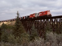 West of Stettler and east of Lacombe on the aptly named Lacombe subdivision, CP used to cross Tail Creek at mileage 74.3 between Nevis and Macbeth on a straight timber trestle bridge of significant proportions, later bypassed to the north by a curved fill with a culvert.  On Thursday 1978-09-14 at 1021 MDT, that bridge was traversed by an eastward ballast work train with GP9s 8834 and 8662 for power.