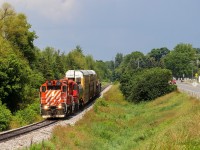 OSR 1591 (GP9u) and OSR 8235 (GP9u) run parallel to Beachville Rd. as they pull 7 cars back towards Ingersoll. As both GP9us are Ex CP and the track used to be operated be Canadian Pacific, this scene is a modern day replica of scenes from the past. To top it all off, the OSR train had to wait for a CN at Carew for about 25 minutes. In that time, a short thunderstorm passed and just as the T-storm cleared, the OSR appeared in perfect storm light. 