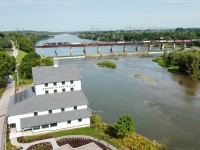 CN L502 spans the Grand River in Caledonia Ontario as the "new" Old Mill stands guard.  The Caledonia Mill is a local landmark and was in dire shape.  A group of Caledonia residents purchased the property and built an exact replica of the mill in its place along the river.