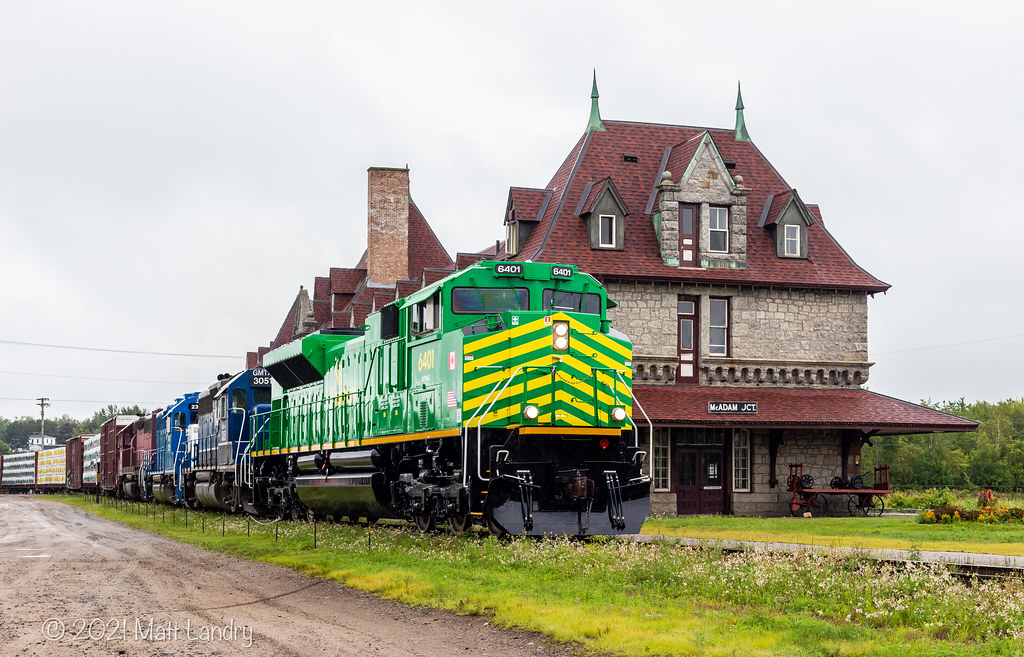 On it's maiden voyage, NBSR 6401 pulls train 907 by the famous railway station in McAdam, New Brunswick.