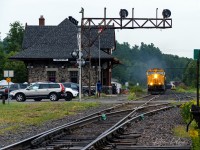 A very late running Southbound 214 passing the Temagami Station under light rain.
<br><br>
MP 71.7 Temagami Sub - July 24