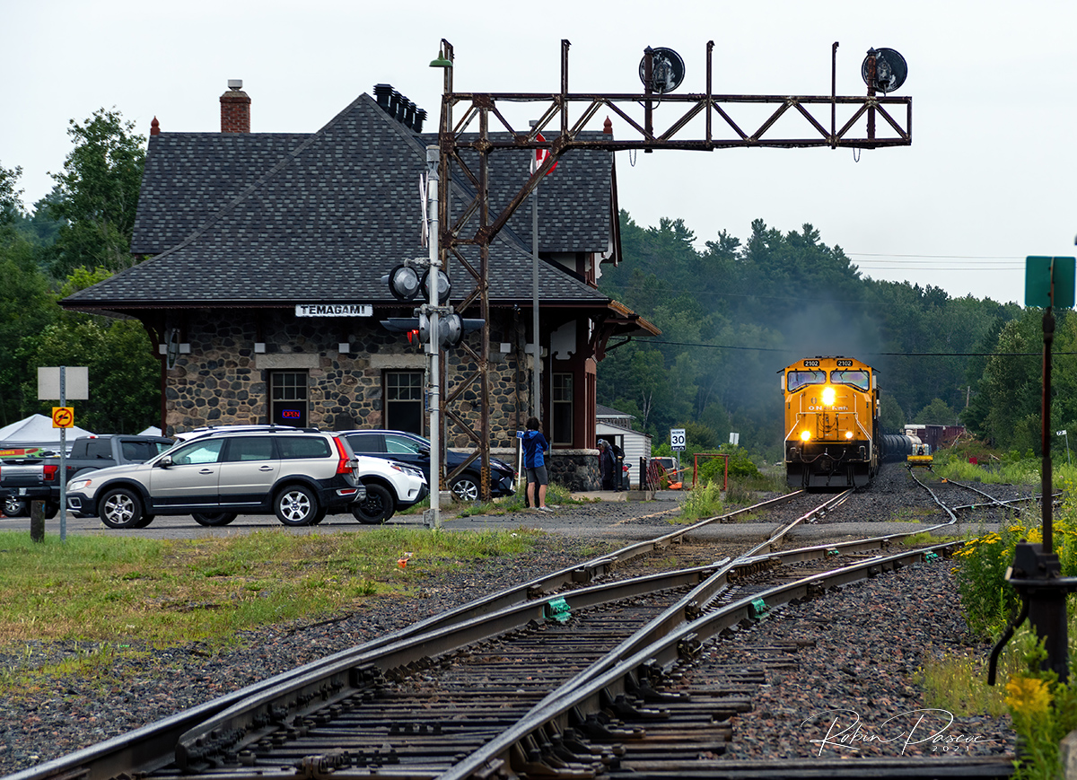 A very late running Southbound 214 passing the Temagami Station under light rain.

MP 71.7 Temagami Sub - July 24