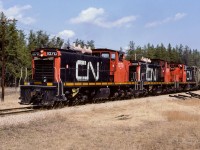 Grain loads on the way home to Edmonton on a sunny Saturday afternoon. These 3 units worked together for several trips, which was great. Every number board has my favourite character used for the numerals. Photo taken at mile 24.4. 