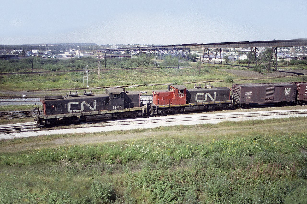 Every time I look at photos like this I rather kick myself for not finding the time to shoot more of them. And now that the GMD-1s are off the roster, it bothers me even more.  This was a nice catch, CN 1905 and 1913, working in Thunder Bay, taken while I was on my way 'out west' in 1976. There no doubt was a lot more to see, but anyone driving across the country knows time is of the essence, and it would be easy to spend a whole day wandering Thunder Bay. So I moved on.
This view is looking west toward the hills of old Port Arthur.