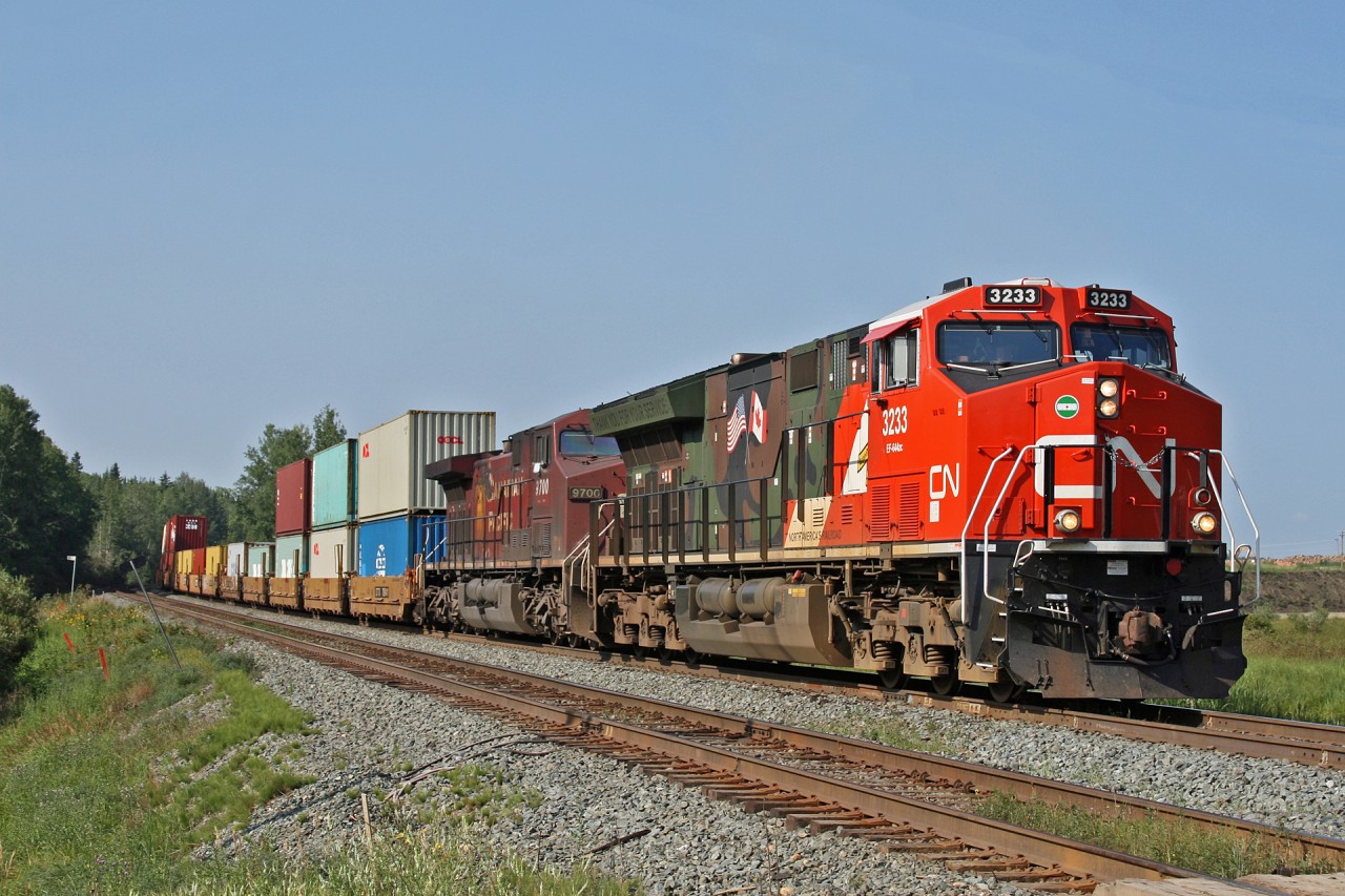 CN Q 19651 25 gets underway after a crew change at Edson with CN 3233 and CP 9700.