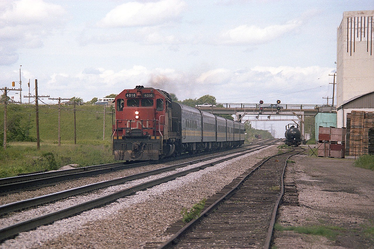A look eastward by the old Aldershot Cold Storage facility. Far background on the left, beyond the Waterdown Rd overpass is where the current sprawling GO Aldershot station is now located. Close left was location of the long gone Aldershot CN station.  Both sets of signal bridges in photo are gone, as is the siding on the right. The 4016, a GP40, was slated to be renumbered to 9316 in a couple of months, along with the others in the 4002-4017 series..9302-9317......lots of change.......maybe, just maybe..... those old VIA coaches are still around.