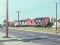 Long story to this one of a kind photo. I did not like to bring my regular camera with me when shopping. I found a nice second hand German made 110 camera that would easily fit in a cubby hole of the car dashboard. Which lead to this one photo I have of a freight passing through downtown Fort Saskatchewan. Right in front of the Fort Mall :-). It has just finished honking for the first 4 crossings and is getting ready for the 5th. No doubt, residents gave a huge sigh of relief when the line was moved out of town in 1987. The 4302 is followed by the 9177 and 9176 as they slowly head east on the way to Vermilion. I'm happy that little strip of film sat nice in the film holder for the scanner. Wow, just drove down here on Google, this whole area has changed considerably. Pretty sure this is 1985 or possibly summer of 86.