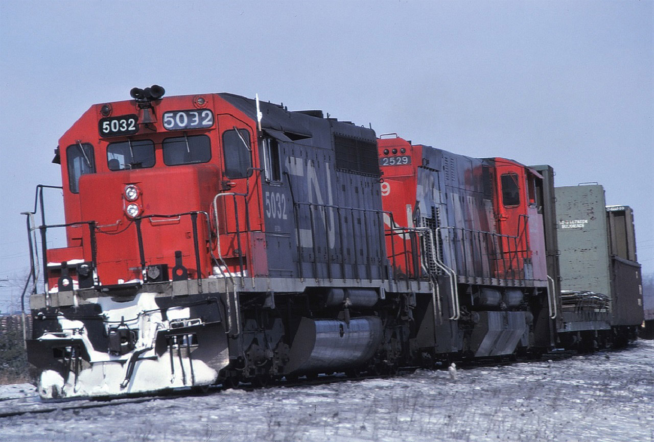 A westbound CN freight comes off the Halton Sub at Burlington, Ontario.  Power is a standard CN SD40 #5032 and M420 #2529.