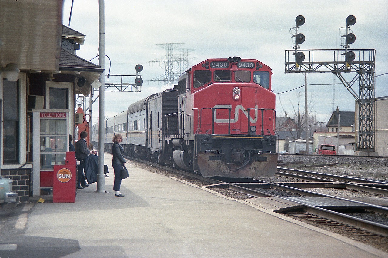 There were a few low numbered GP40-2L(w) locomotives on CN geared for 80MPH and they fit right in helping out VIA when necessary. Here we see CN 9430, with steam jenny behind, slowing in for a stop at Burlington West station. The woman in the photo looking over sure doesn't seem to approve of me. Not a problem, believe the feeling is mutual. I was there for the train. Besides, CN 9430 was sold to ALSTOM in 2001 and I'll bet she still looks pretty good.