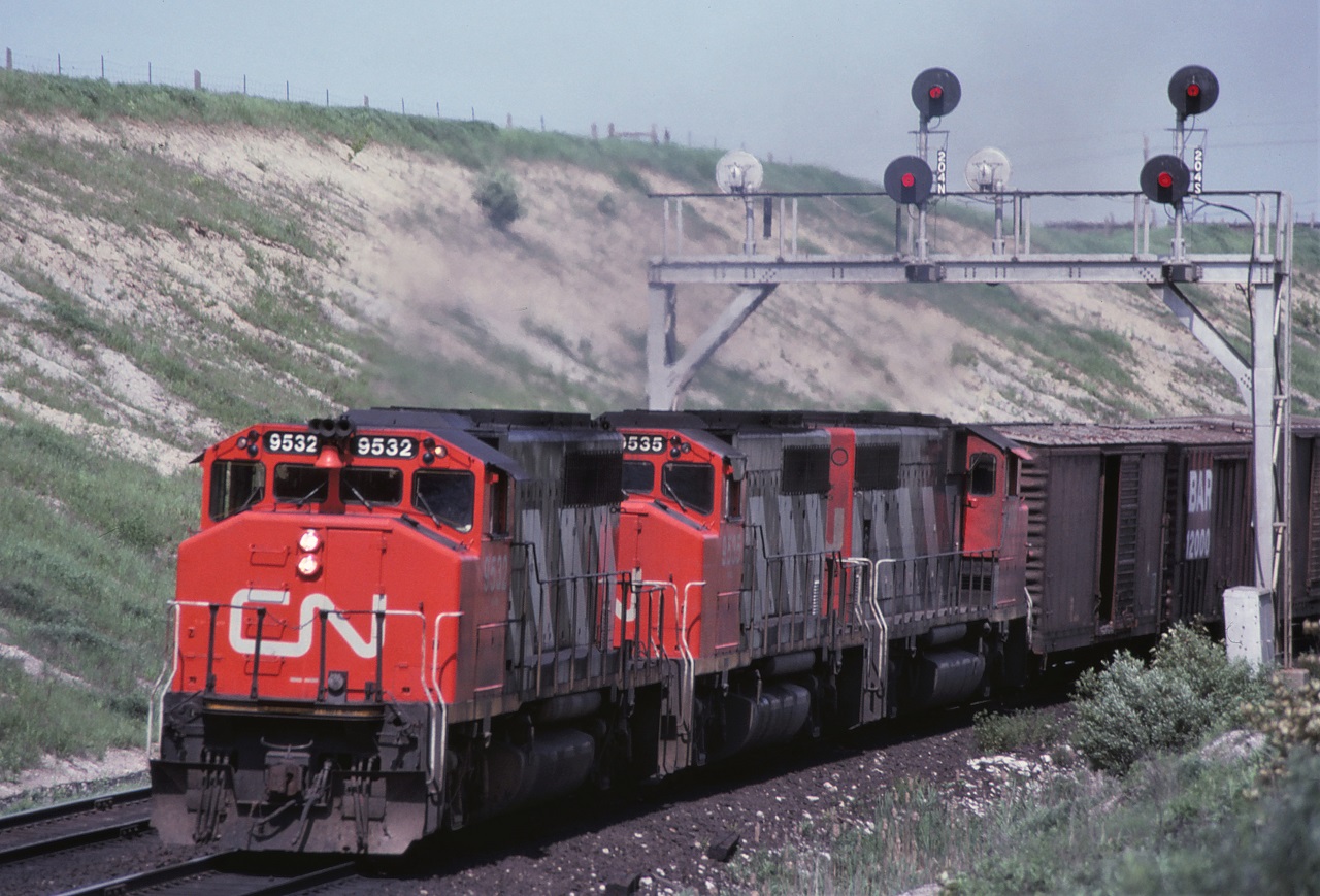 A westbound CN freight with an oh so common trio of "9400s" screams uphill on its way to Toronto Yard on June 3rd 1974.  Forty seven years later, I now realize I should have also taken a picture of the second car.