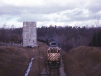 As I put this shot to RP I get to wondering how many train buffs recall an old grain silo and corresponding siding in view looking north off that old wooden bridge that spans the CP in Waterdown. The location is where Snake Rd meets Main St., which is just off to the left in this image. We're going back 47 years, and its days were already up, by the look of it. Unfortunately this image is from before I carried a notebook, and only from a blurred previous image was I able to discern the units behind the GP38 leader #3014 are two F units sandwiching an old RS-3. Incredible, really, that 3014 is still on the roster; having flirted with retirement back in 2013-2015, but ventured back on the road again.